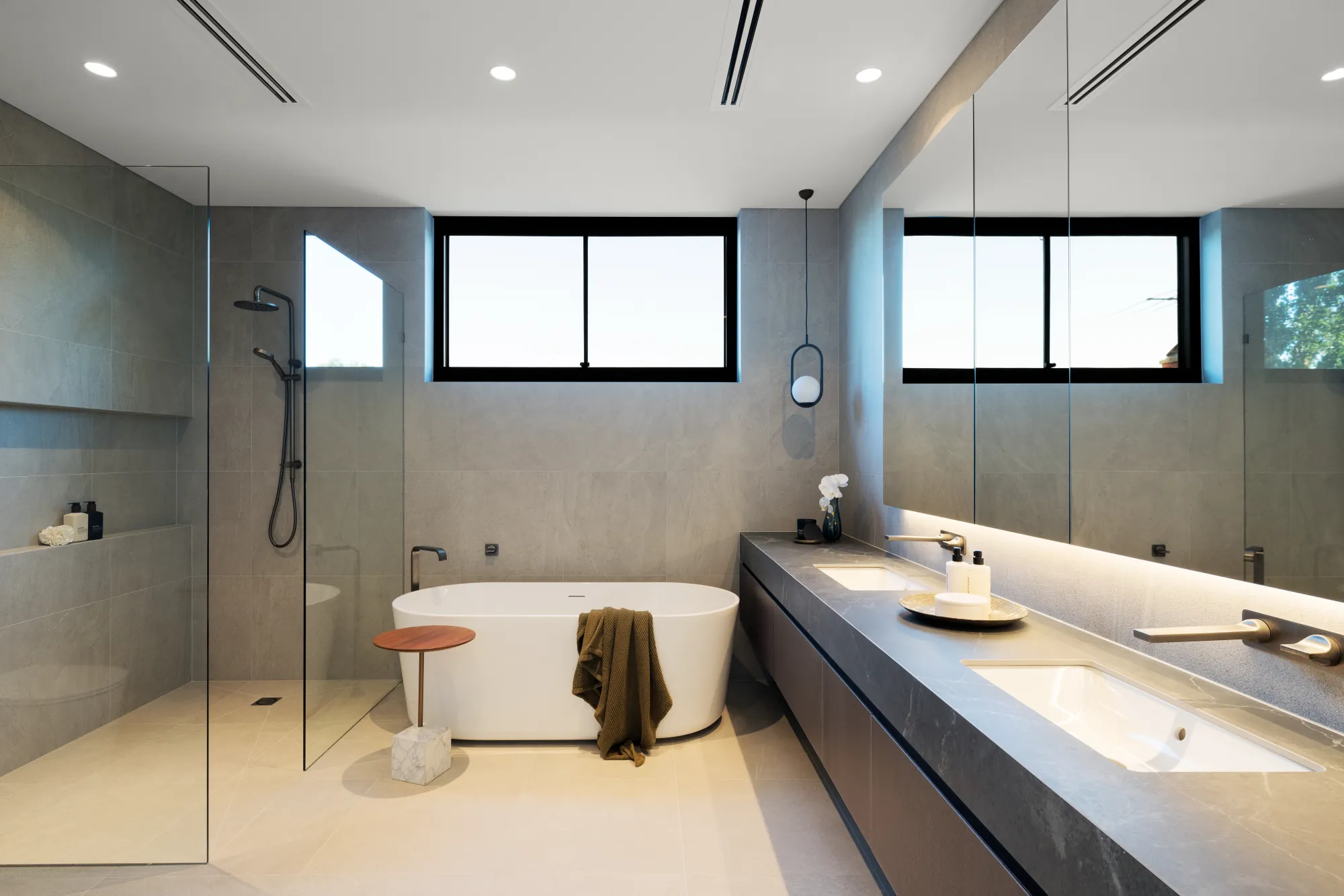 Renovated main bathroom with a freestanding bath, walk-in shower and twin stone vanity